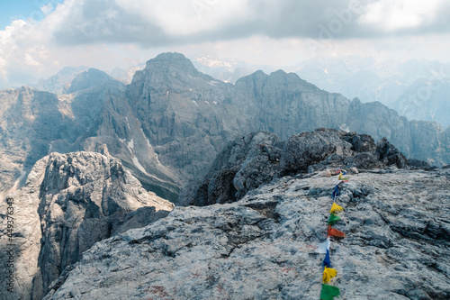 String with colorful bits of cloth on it on Prisojnik, Slovenia under a cloudy sky photo