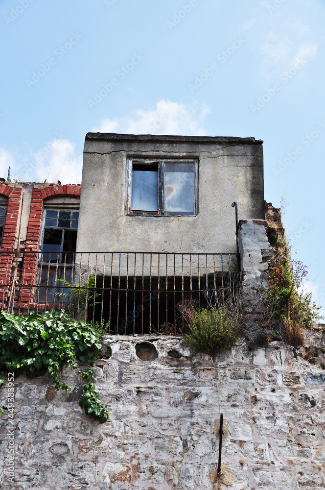 Old stone house. The house is on a high stone foundation. Summer day. Istanbul.