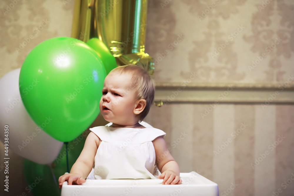 Obraz premium Birthday one year old girl with baloons