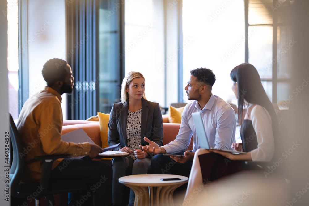 Diverse group of business colleagues using laptop and having meeting Diverse group of business colleagues using laptop and having meeting