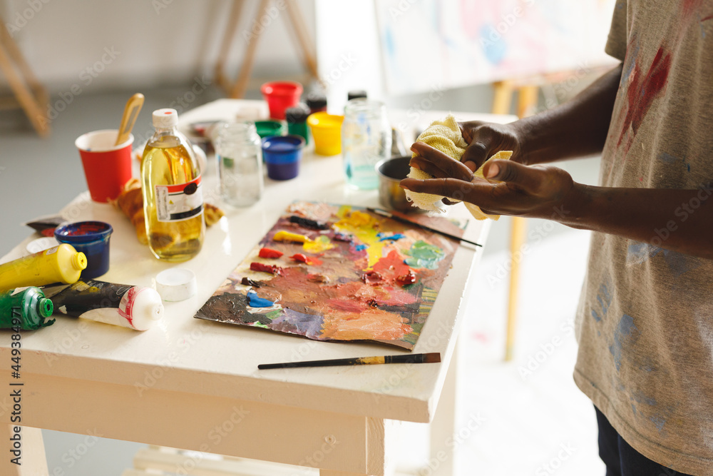 African american male painter at work cleaning hands in art studio African american male painter at work cleaning hands in art studio