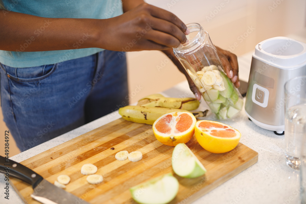 African american woman in kitchen preparing health drink African american woman in kitchen preparing health drink