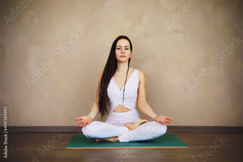 Beautiful athletic girl doing yoga exercises enjoy meditation at home. No stress, healthy habit, anxiety relief concept. Lotus pose.