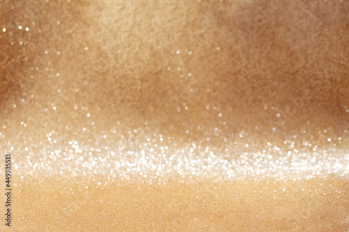 Golden glitter background with focus onwards