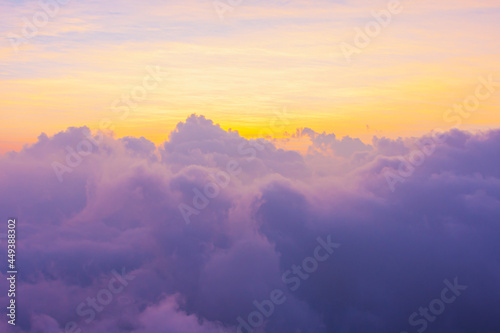 beautiful gold sunlight of sun while sunrise or sunset with soft purple cloud above peak mountain