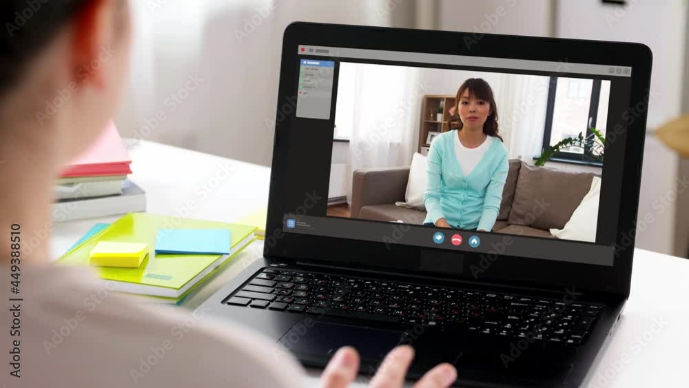 communication, technology and people concept - woman with laptop computer having video call with friend at home communication, technology and people concept - woman with laptop computer having video call with friend at home