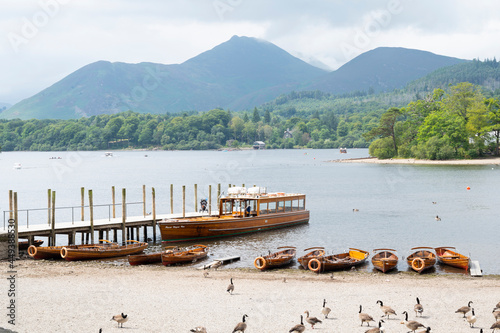 Keswick, English Lake District, U.K. 28 July, 2021. Beautiful view of the lake, bridge and boats, best travel place in U.K photo