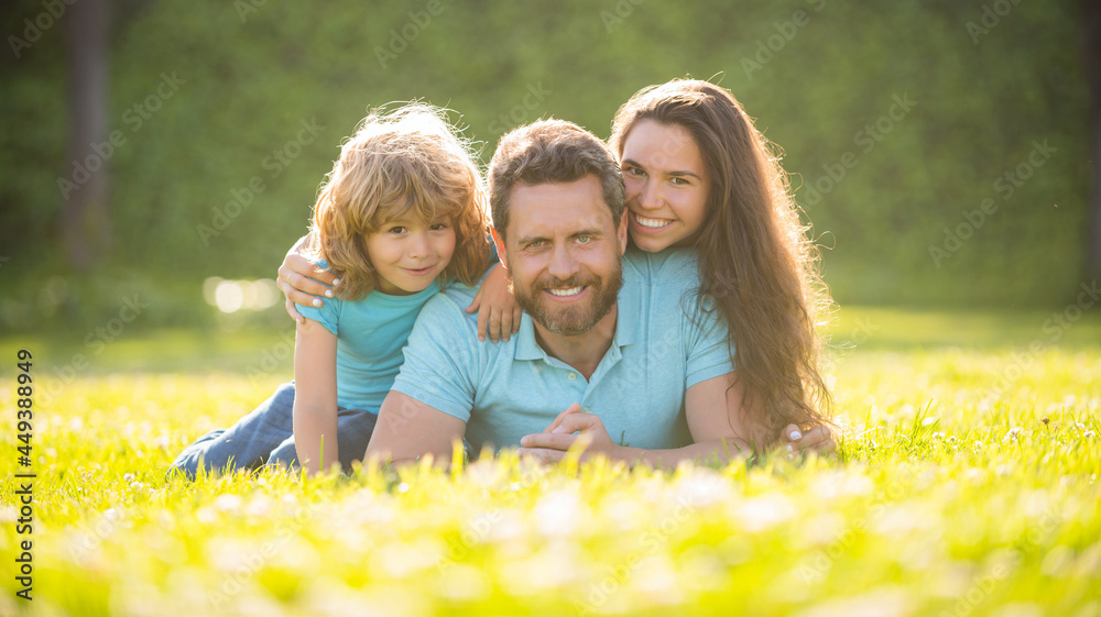 Fototapeta premium adoption and charity. family day. friendship. father mother and child on green park grass.