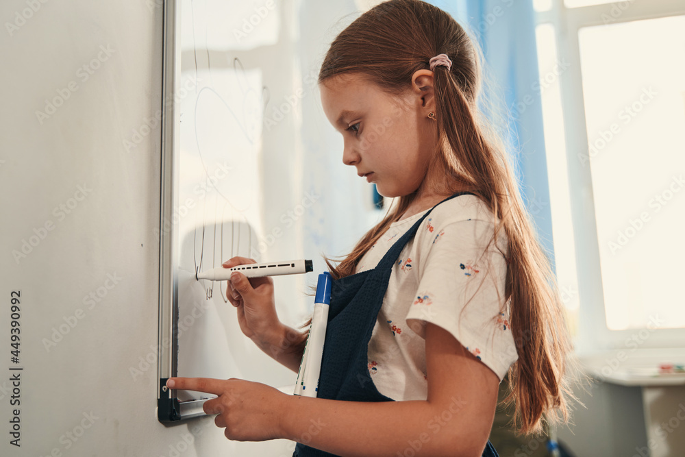 Child adding important details to her picture Child adding important details to her picture