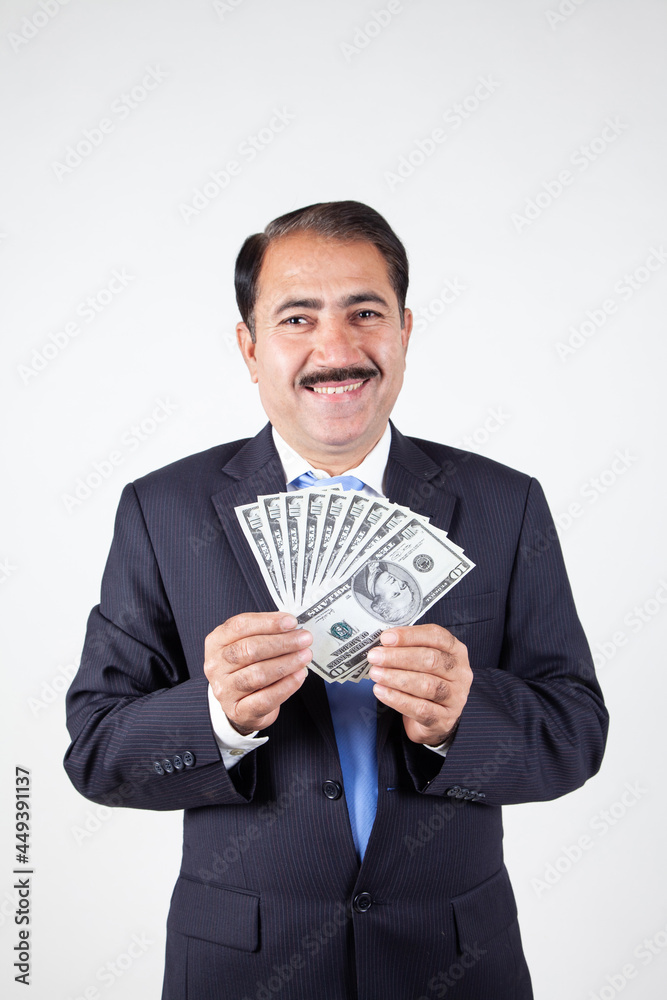 Mature company business man holding money showing prize winner in hand Mature company business man holding money showing prize winner in hand