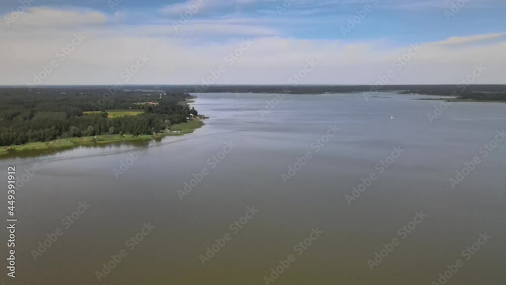 A bird's-eye view of the Siemianówka dam reservoir in the upper Narew valley.A bird's-eye view of two water pools separted track connected by a bridge. 