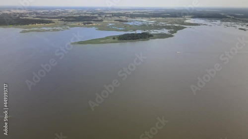 A bird's-eye view of the Siemianówka dam reservoir in the upper Narew valley.A bird's-eye view of two water pools separted track connected by a bridge.  photo