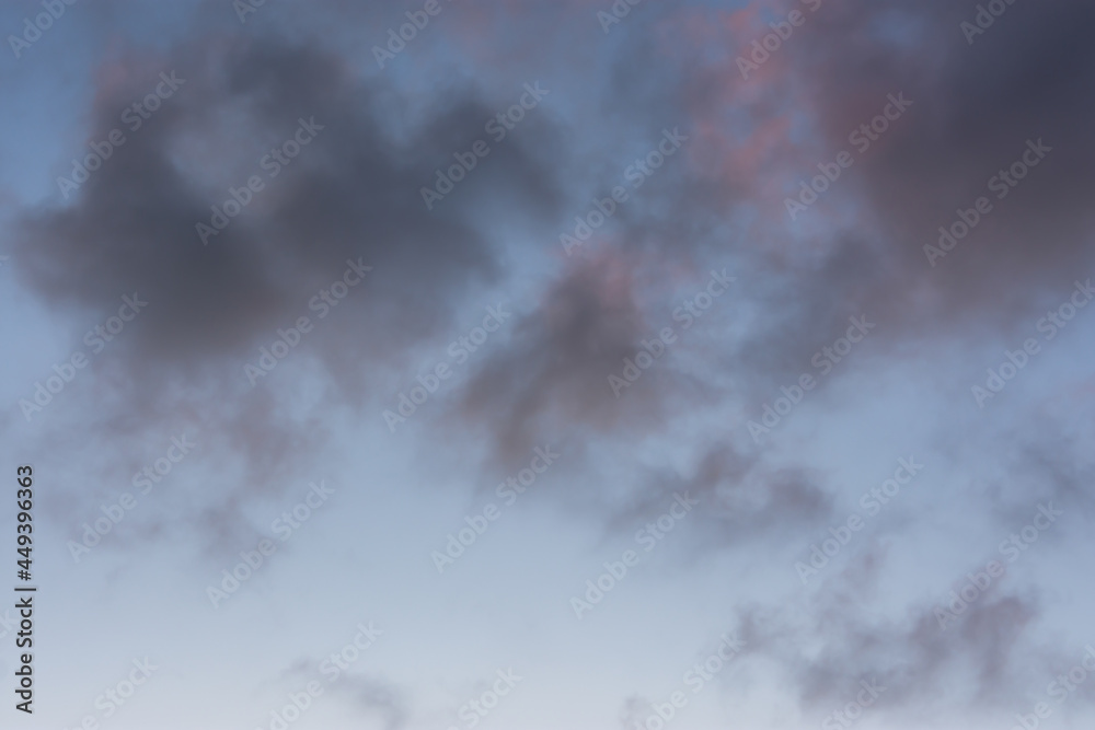 Obraz premium Clouds sunset background. Pastel delicate shades of the sky. Beautiful clouds for an airy light summer design. The concept of lightness, weightlessness, romance, tenderness. Sky with purple clouds