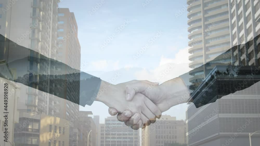 Mid section of businessman and businesswoman shaking hands against tall buildings in background Mid section of businessman and businesswoman shaking hands against tall buildings in background