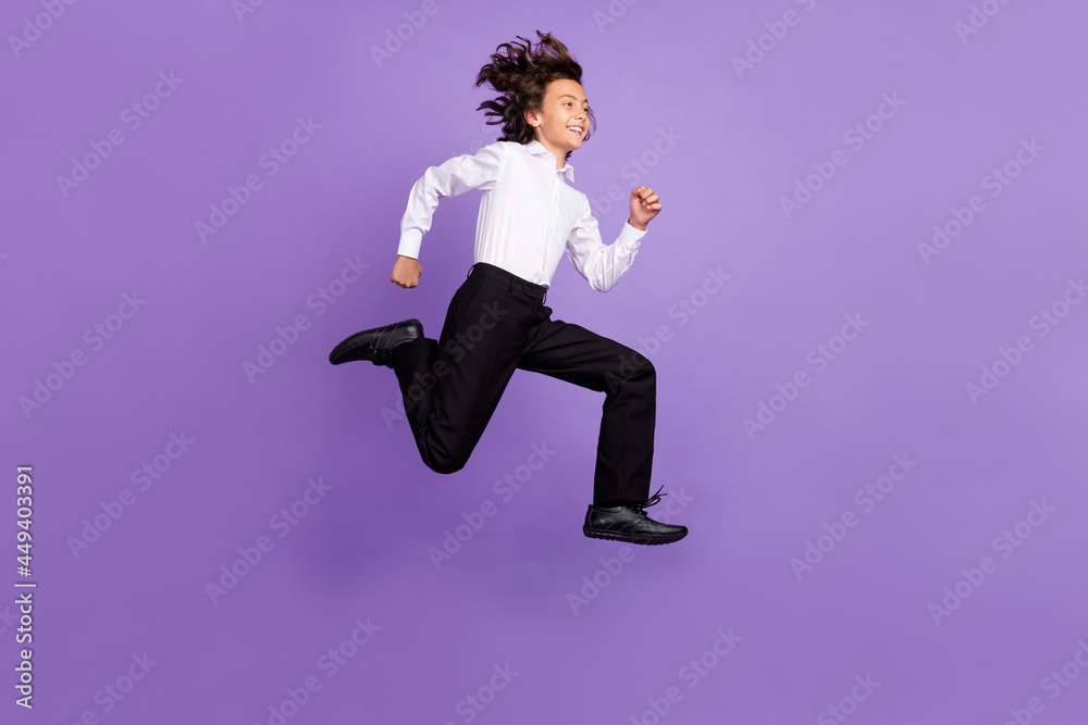Full body photo of funny little brunet boy run wear shirt trousers sneakers isolated on purple color background