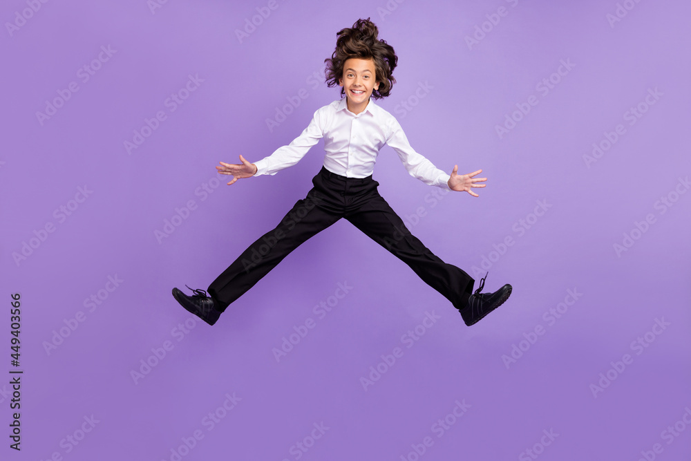Full body photo of funny little brunet boy jump wear shirt trousers sneakers isolated on purple color background