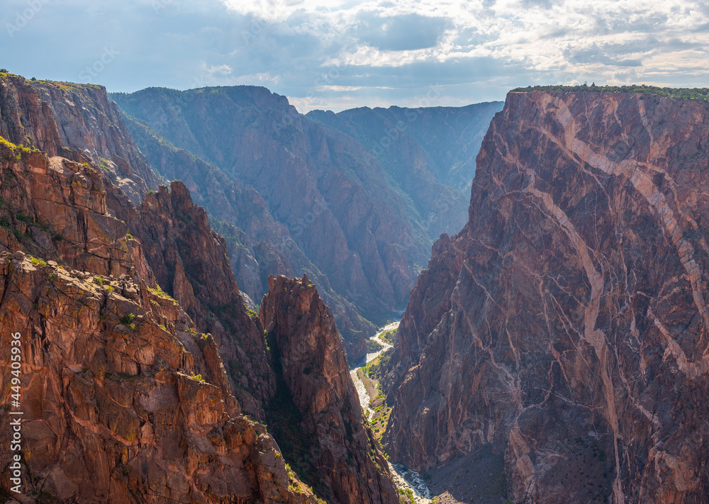 Black Canyon of the Gunnison with two dragons and the Gunnison River cutting through the rock in valley, Colorado, USA.
