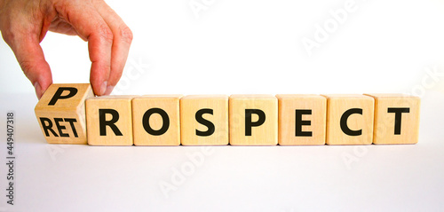 Prospect or retrospect symbol. Businessman turns a cube and changes the word 'retrospect' to 'prospect'. Beautiful white background. Business and prospect or retrospect concept. Copy space.