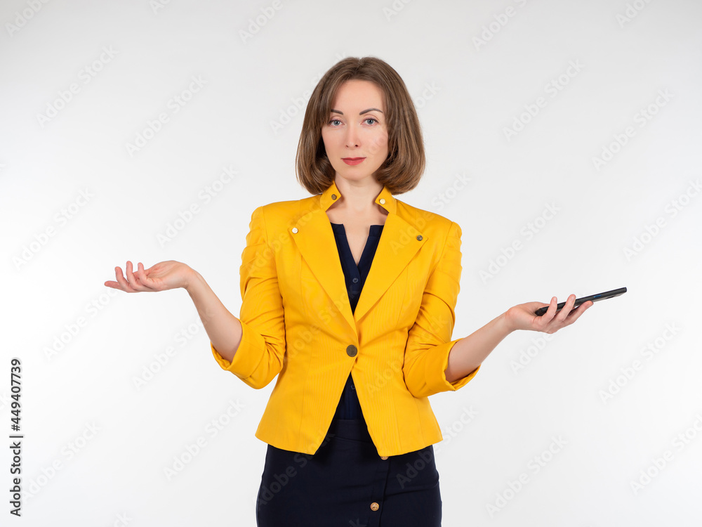 Woman on a white background. Stylish girl holding a smartphone. She throws up her hands. Businesswoman with the phone. Young woman in a yellow jacket. Portrait of a businesswoman with a smartphone. Woman on a white background. Stylish girl holding a smartphone. She throws up her hands. Businesswoman with the phone. Young woman in a yellow jacket. Portrait of a businesswoman with a smartphone.