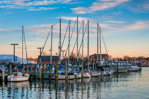 Sailboats in a marina at sunset along the waterfront in Annapolis, Maryland.