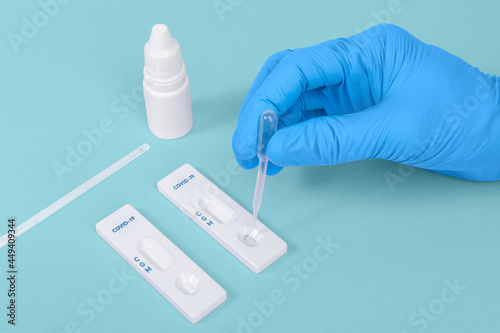 scientist or doctor hand using Rapid antigen test cassette quick fast testing identifying antibodies for COVID-19 Coronavirus Dropping sample in antigen taplet
