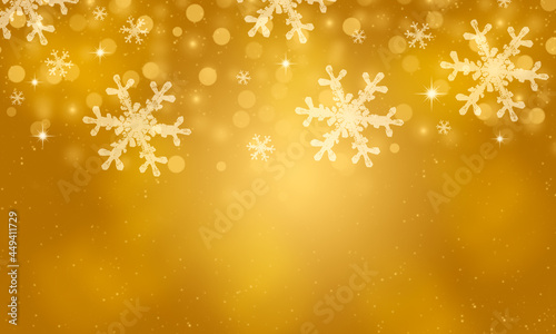 Abstract gold winter background with snowflakes and glitter lights.