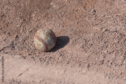 baseball on red clay sand (pitcher's mound)