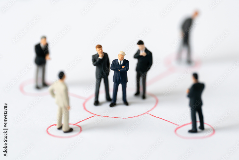 Miniature people Group of Businessman mini figures standing thinking on Graphic Info white background using as Success Business partnership development and Commerce Strategy winning Planning concepts Miniature people Group of Businessman mini figures standing thinking on Graphic Info white background using as Success Business partnership development and Commerce Strategy winning Planning concepts