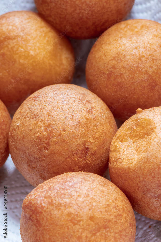 Buñuelos on a white plate in the foreground. Buñuelos on a white plate in the foreground.
