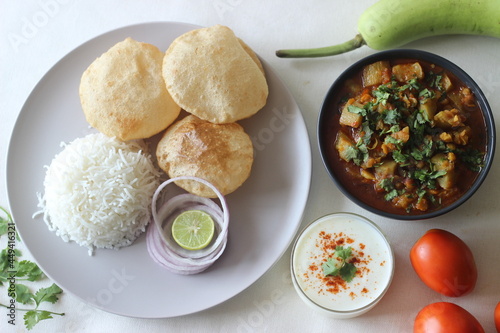 North Indian vegetarian meals. One pot preparation of lentil and bottle gourd served with steamed basmati rice and deep fried whole wheat Indian flat bread. photo