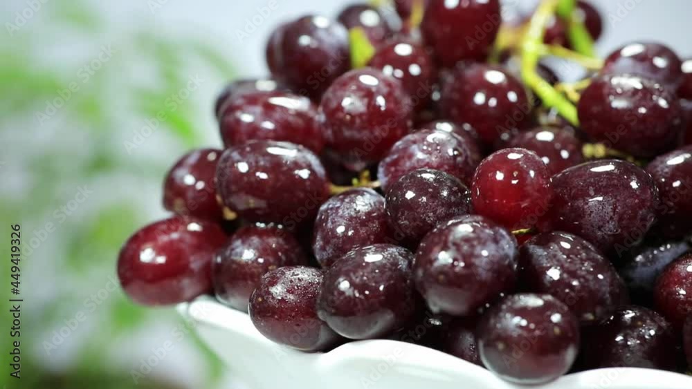 Rotating shot of a plate of crystal-like purple grapes Rotating shot of a plate of crystal-like purple grapes