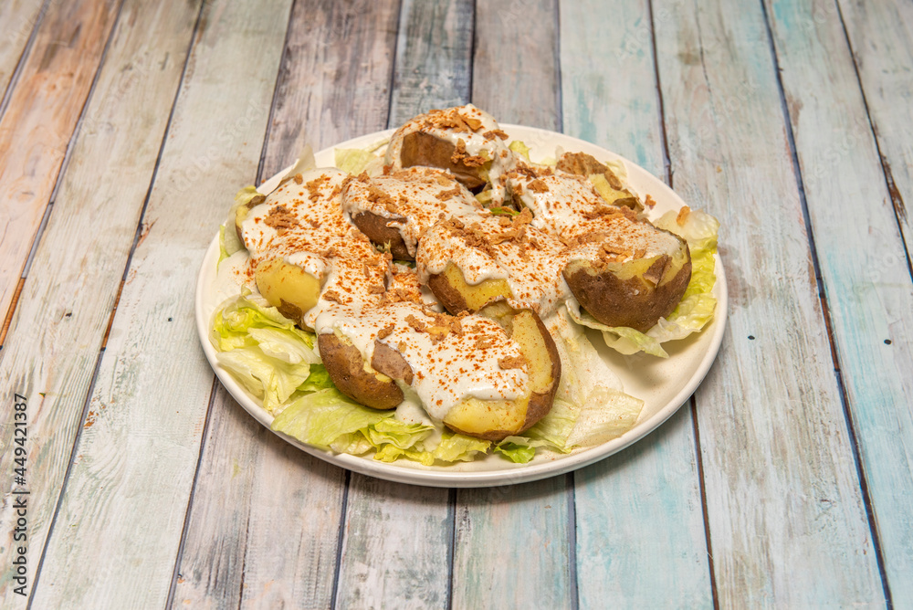 Potatoes cooked in their own skin, cut in half and drizzled with Cabrales cream cheese Potatoes cooked in their own skin, cut in half and drizzled with Cabrales cream cheese