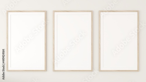 3 white photo frames on the cream wall