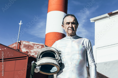 Elderly spaceman standing in spaceport photo