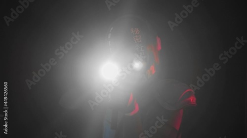 Cyberpunk future concept. Police officer cop, halfman aims around in dar. Bionic cyborg robot is in fume, smoke. Weapon gun with lantern. Science fiction scene, fantasy, sci. Red blue light blinks photo