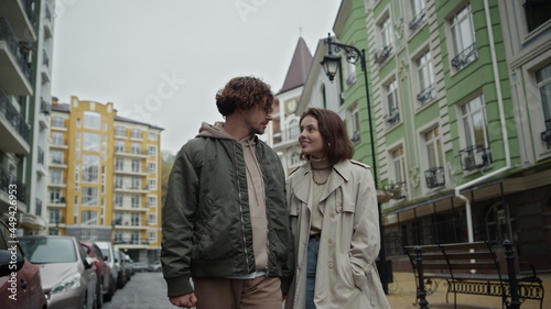 Romantic couple walking on urban street. Man and woman talking together outdoor.