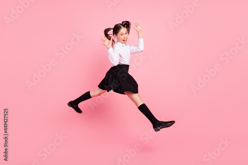 Full length photo of crazy happy cheerful girl jump up walk empty space cool isolated on purple color background