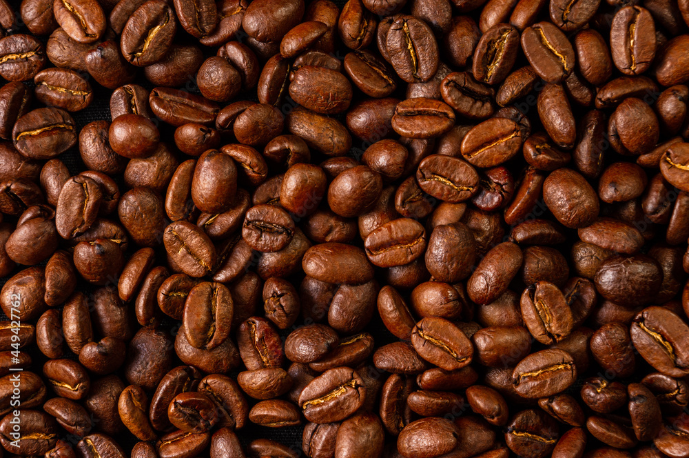Natural background for Cafe menu or brochure template - macro photo of brown roasted coffee beans, close up Natural background for Cafe menu or brochure template - macro photo of brown roasted coffee beans, close up
