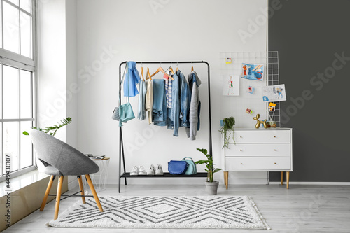 Rack with stylish clothes, ...