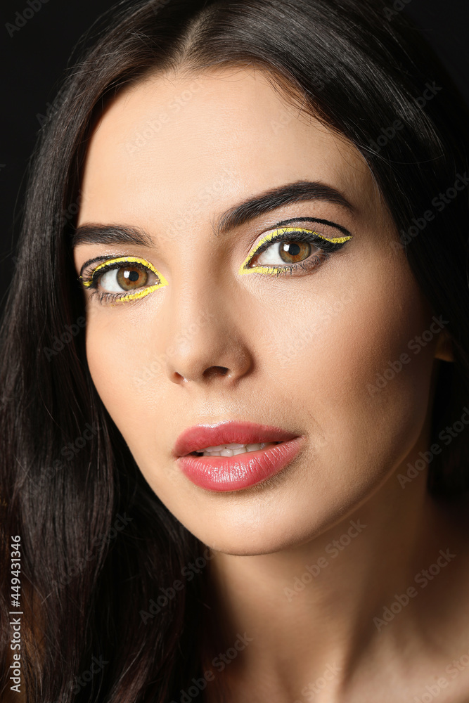 Beautiful young woman with stylish makeup on dark background Beautiful young woman with stylish makeup on dark background