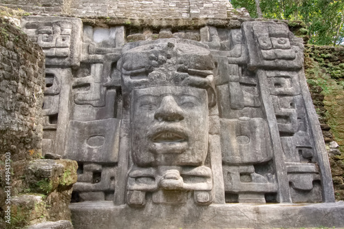 Ancient stone carving at the Mayan ruin of Lamanai, Belize photo