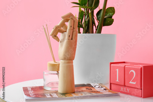 Wooden hand with magazine a...