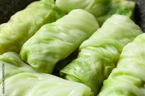 Uncooked cabbage rolls as background, closeup