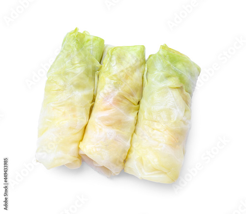 Uncooked cabbage rolls on white background