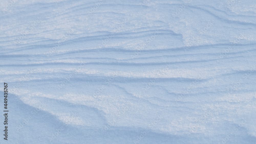 Snowy background, snow-covered surface of the earth after a blizzard in the morning in the sunlight with distinct layers of snow Snowy background, snow-covered surface of the earth after a blizzard in the morning in the sunlight with distinct layers of snow