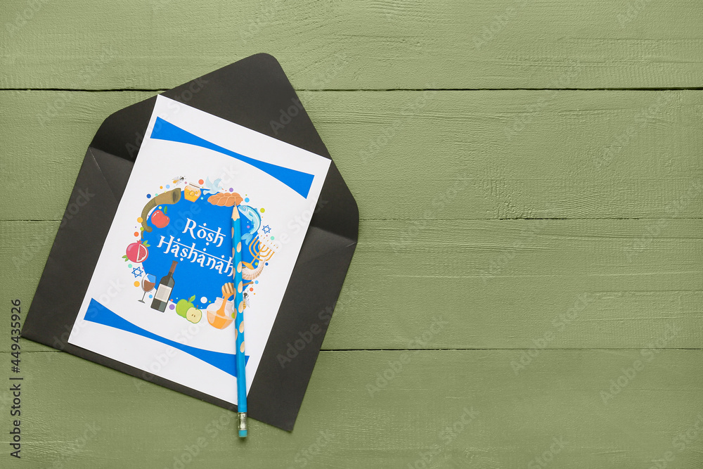 Obraz premium Greeting card for Rosh hashanah (Jewish New Year) with envelope on color wooden background