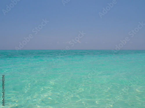 Blue water and blue sky on the horizon of the Indian Ocean in the Maldives. Copy space for text.