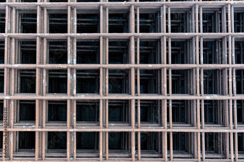 Reinforced steel bars on background of construction site with copy space. Metal base of reinforced concrete walls and buildings.