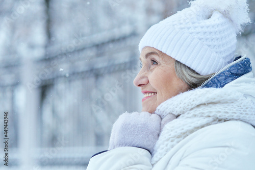 Happy beautiful senior woman in warm hat