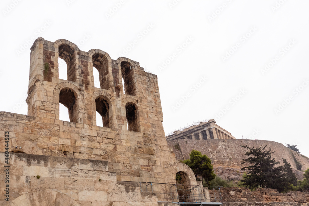 Entrance arches to Odeon of Herodes Atticus on white background on hills of Acropolis, Athens, Greece